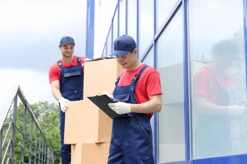Commercial relocation crew handling boxes and desks in Roehampton