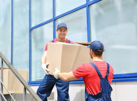 Removal van and moving team in Roehampton residential street