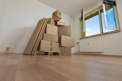 Man and van removals team loading furniture in Roehampton