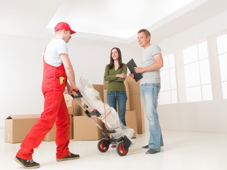 Packed household boxes and furniture ready for transport in Roehampton