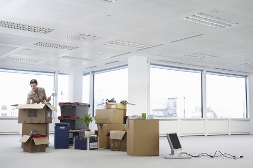 Moving staff wearing PPE while handling boxes and furniture